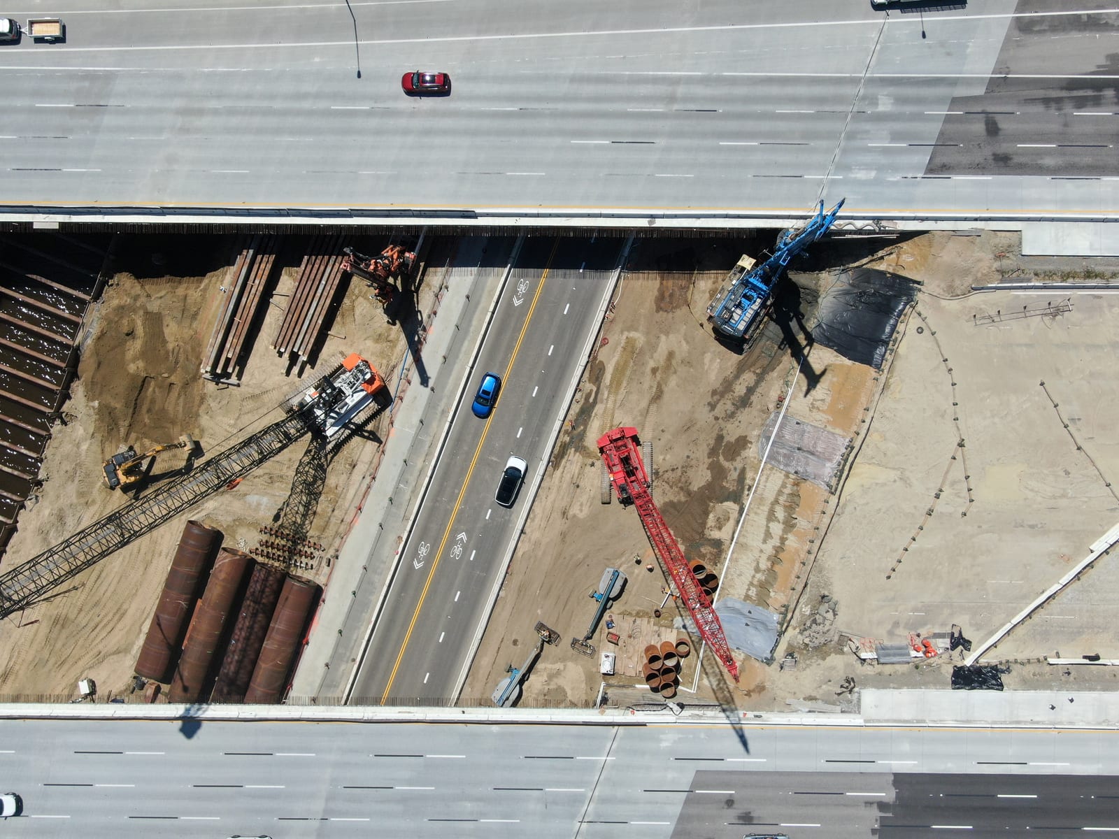 Aerial highway bridge construction site with multiple work zones